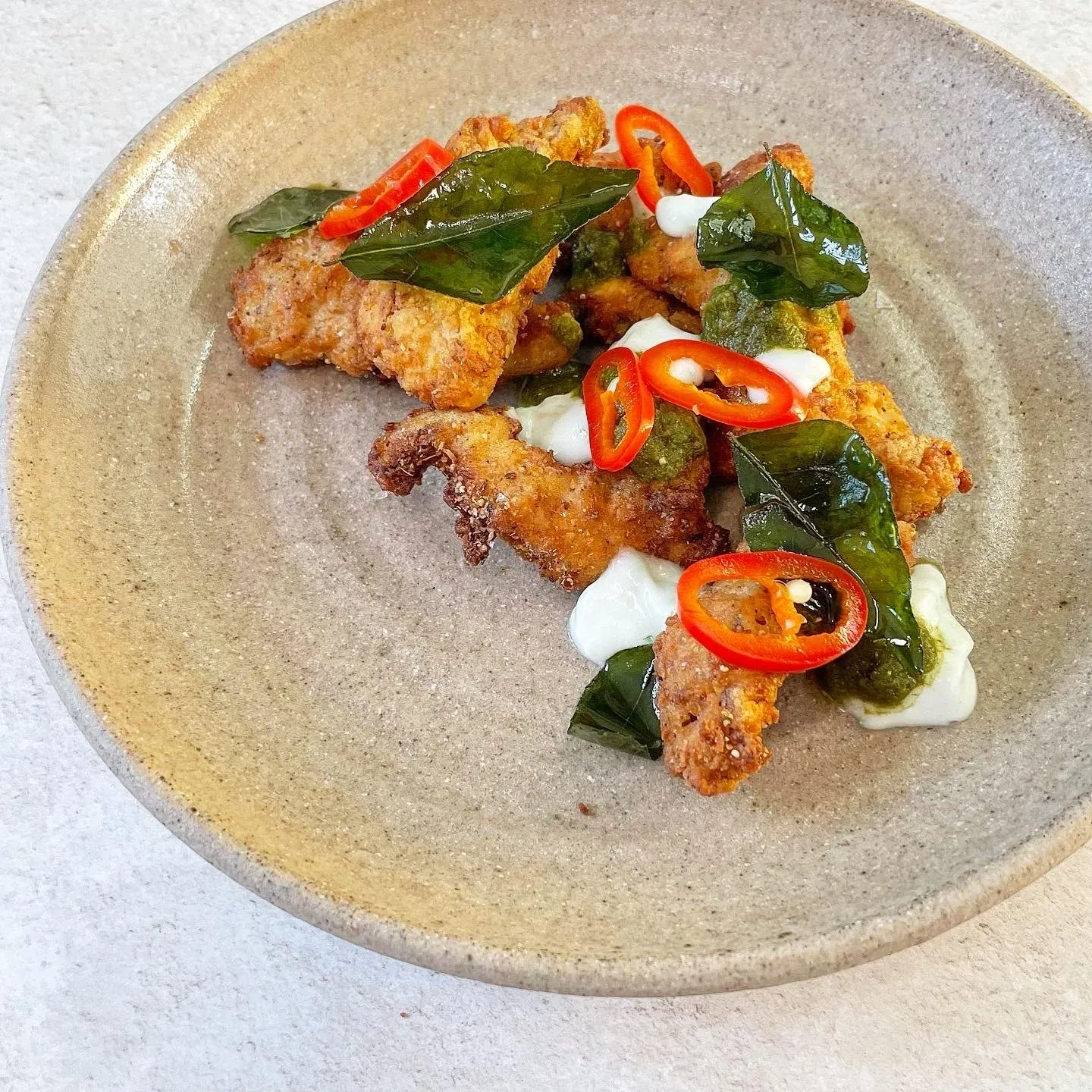 Fried oyster mushrooms, mint yoghurt, pickled chillis and crispy curry leaves