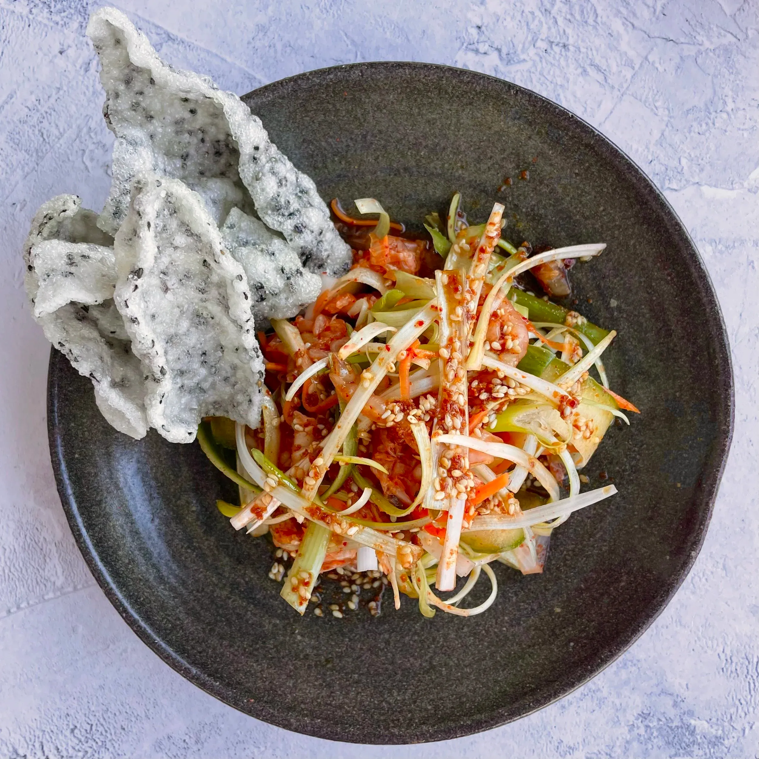 Sesame and gochujang salad with sesame crackers