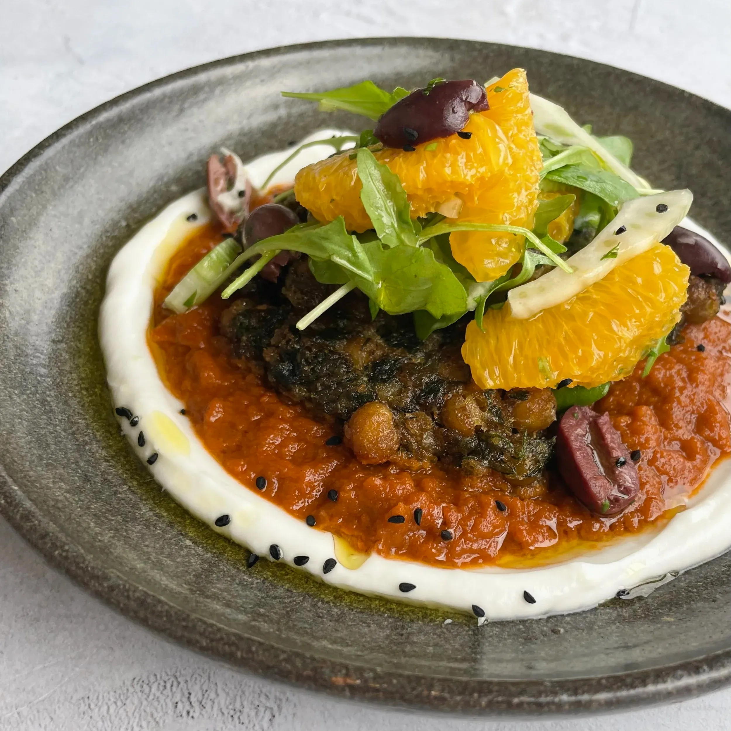 Chickpea fritters, spiced tomato sauce, yoghurt, with fennel and orange salad